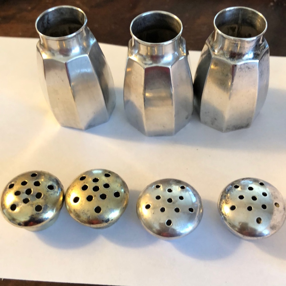 Salt and pepper shaker 3 with 4 lids . 1 3/4 in tall one in base octagon shape.
